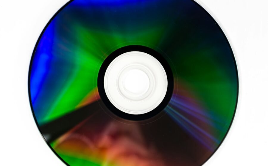 Close-up of a reflective optical disc with rainbow colors, illustrating the future of Blu-ray and physical media; the photo is not identified as a Blu-ray disc