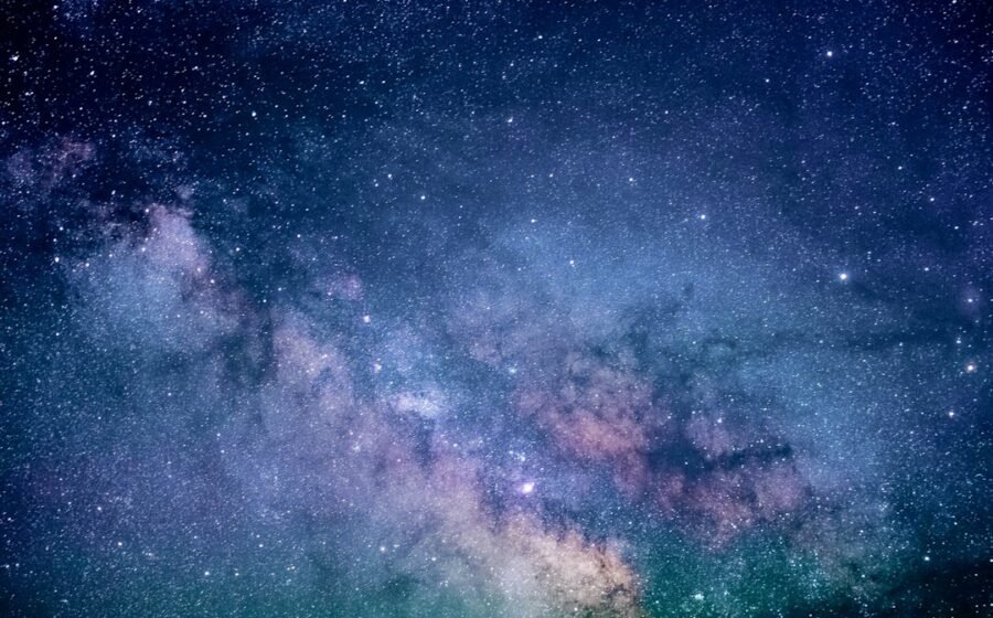 Vibrant deep-space sky filled with stars and colorful gas, illustration of cosmic expansion
