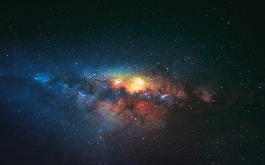 Colorful night-sky stars and galactic clouds, illustrative image for dark energy cosmology