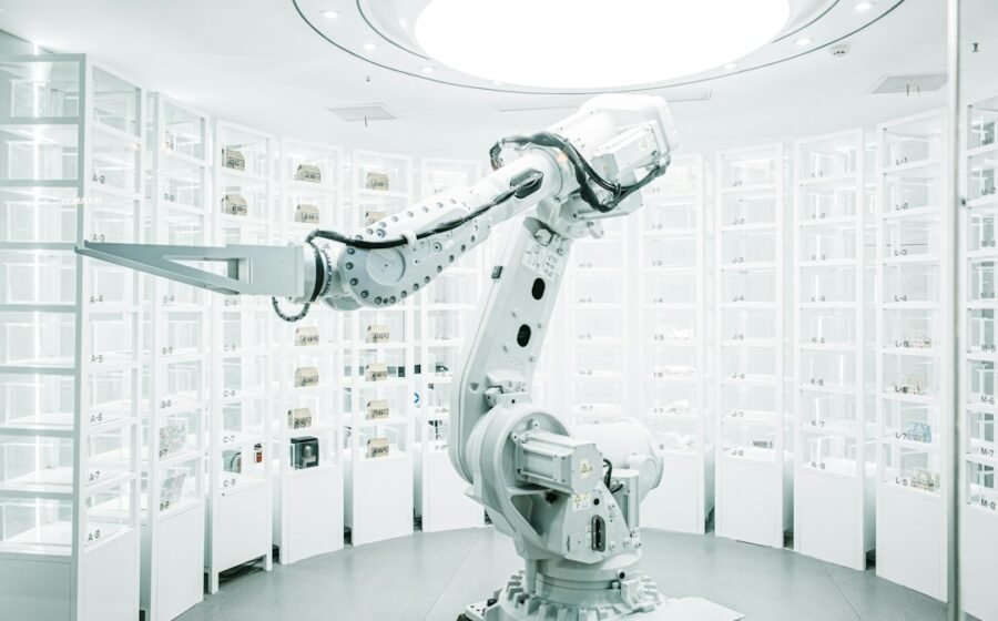 Modern white robotic arm in a technology display, illustrating future invention and engineering
