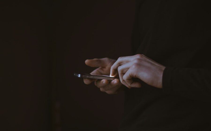 Person using a smartphone, illustrating digital feeds and personalized information environments