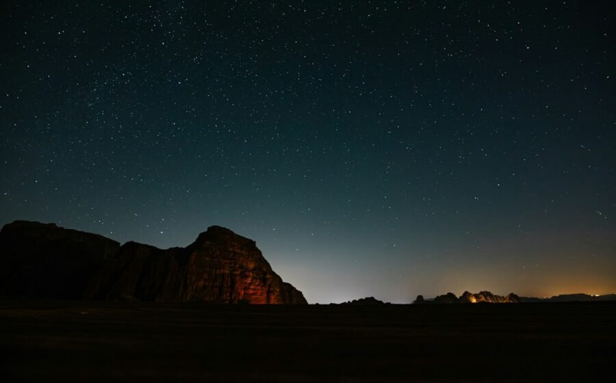 Starry sky above rugged desert mountains, illustrative photograph; not a picture of the reported triangular craft