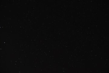 Stars in a night sky illustrating UAP questions; not a photograph of a confirmed UFO