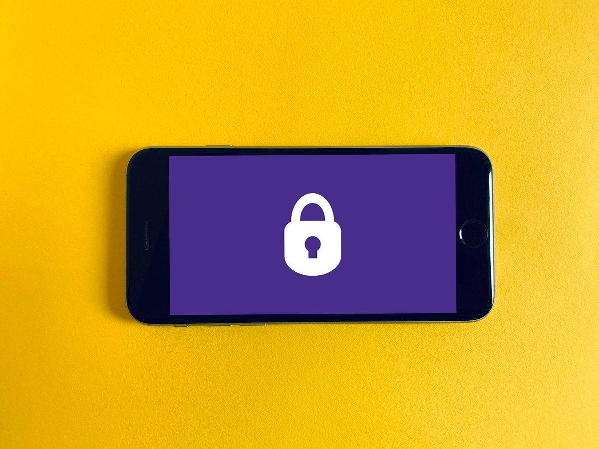 Illustrative photo of a smartphone and a physical lock symbolizing messaging privacy and government data requests; not a Telegram document or screenshot